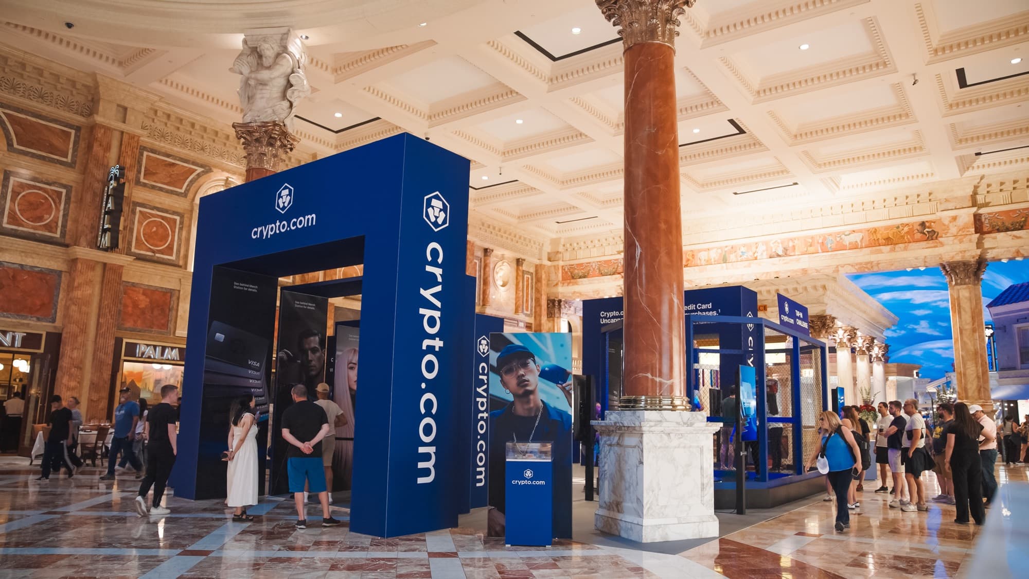 A branded Crypto.com archway activation in a marble shopping arcade